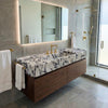 Premium bathroom styling with a natural stone long console sink with brass stand