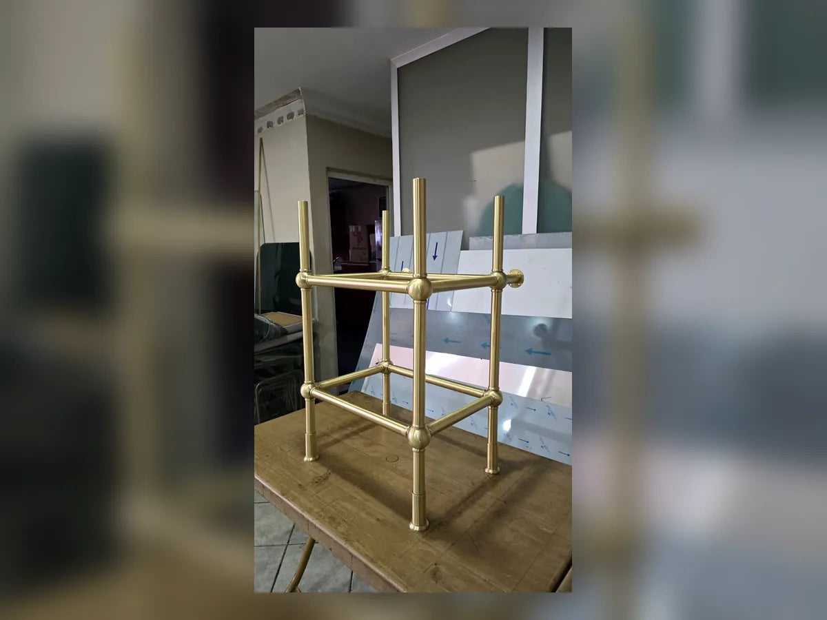 Polished brass stand detail for a custom marble sink
